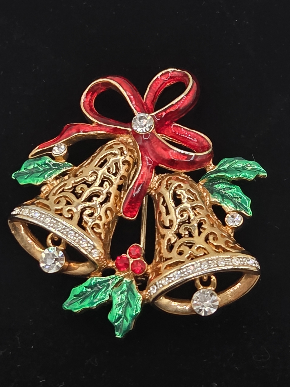 Festive Gold Bell Brooch with Red Bow and Green Leaves